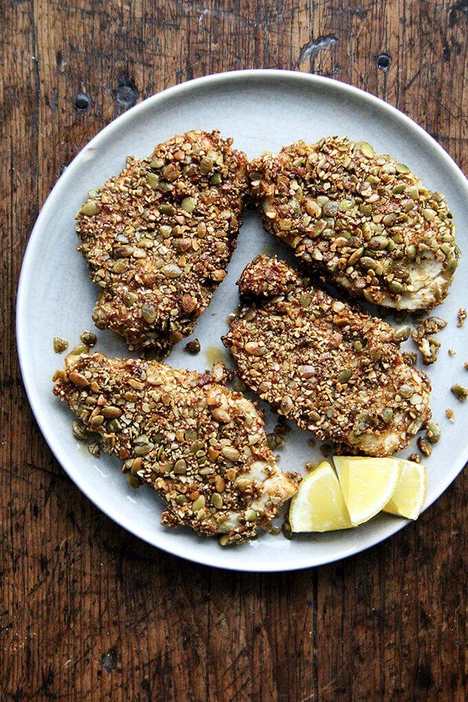 Here's the gist of these pepita-crusted chicken cutlets: toast pumpkin seeds, crush them coarsely, mix with a few spices (smoked paprika or ancho chile powder, cumin and cayenne), then use them to "bread" your cutlets. If you love panko chicken and are looking for a little change, give this one a go—the seeds add such a lovely texture and flavor. // alexandracooks.com