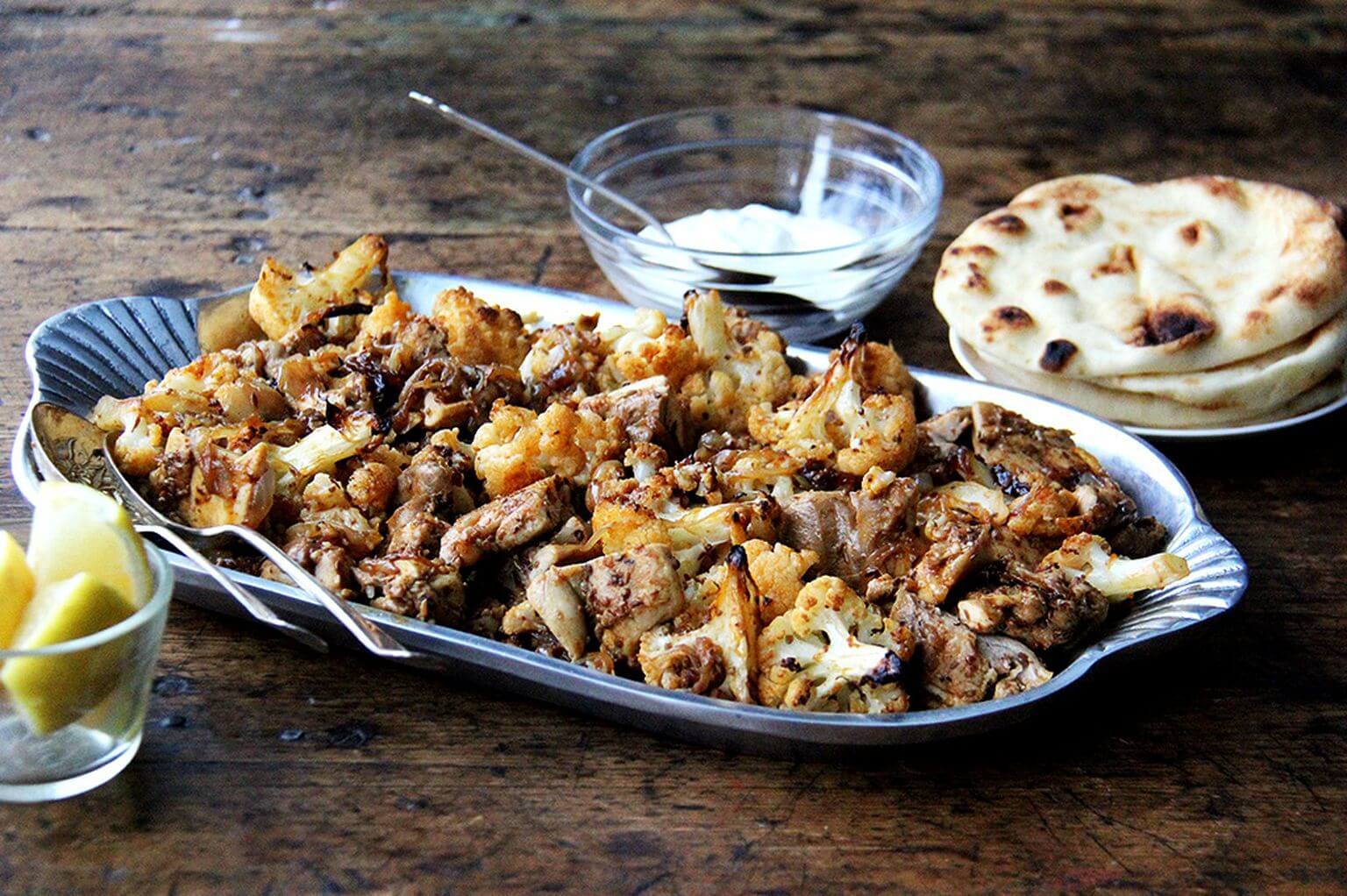 A platter of sheet pan chicken and cauliflower shawarma. 