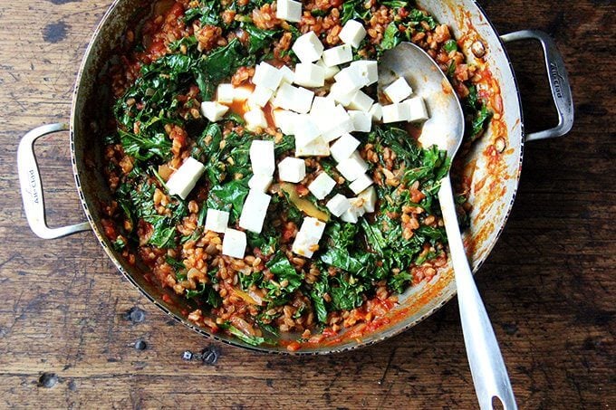 Overhead shot of farro risotto with kale and feta added. 