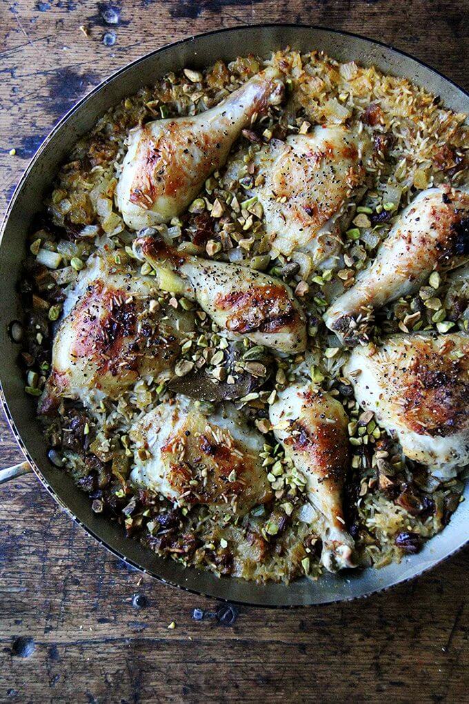 An overhead shot of one-pot Moroccan chicken and rice with dates, harissa, and pistachios.
