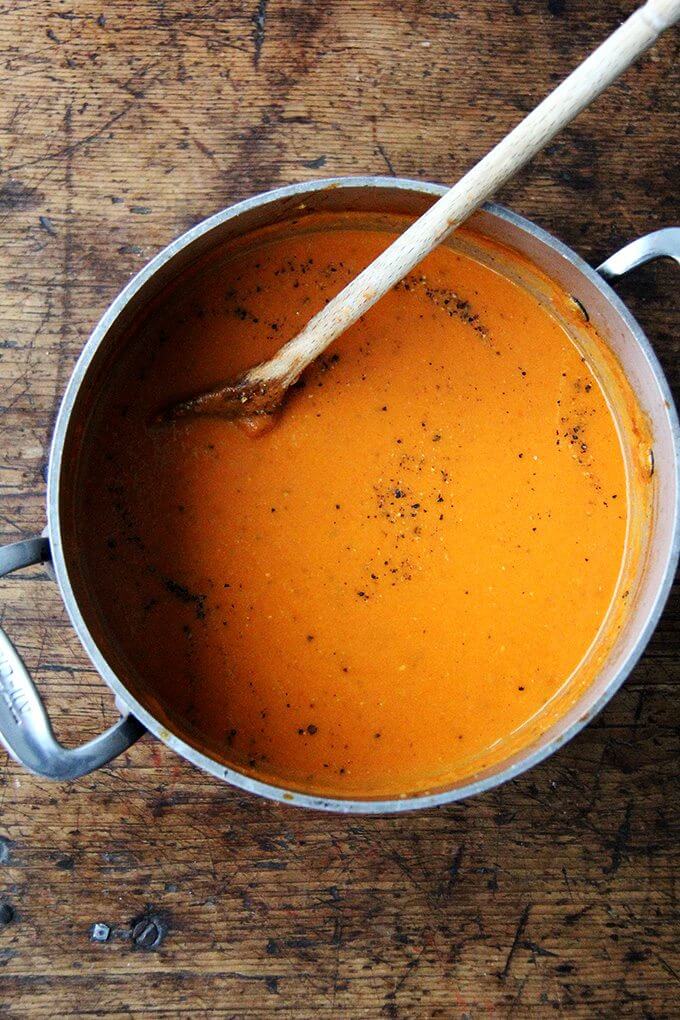 A large pot of puréed pantry tomato soup.