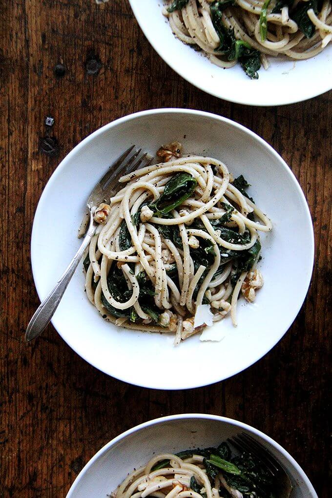 This pasta with spinach, walnuts, and lemon includes fresh greens tossed with a garlicky, white wine sauce made slightly creamy with crème fraîche. Yum. // alexandracooks.com