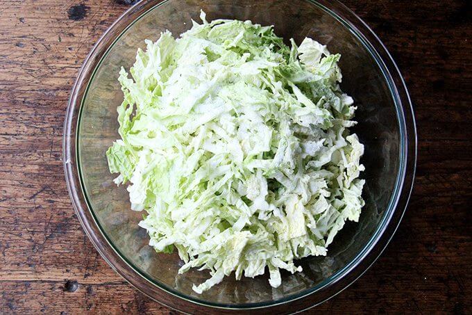 A bowl of shredded cabbage, salted. 