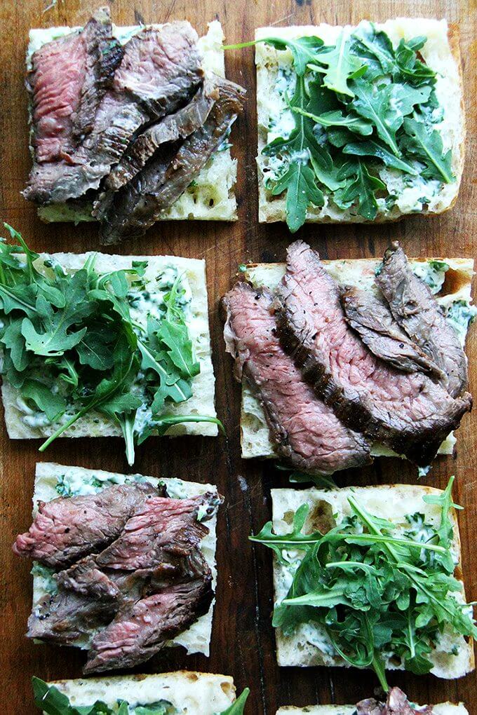 In these skirt steak sandwiches, skirt steak, which cooks to medium-rare in just about 5 minutes, is layered with arugula between slices of focaccia smeared with herbed mayonnaise. The key, as with all meats, is to let the steak rest for at least 10 minutes before slicing, and with skirt steak, to slice it thinly against the grain. // alexandracooks.com