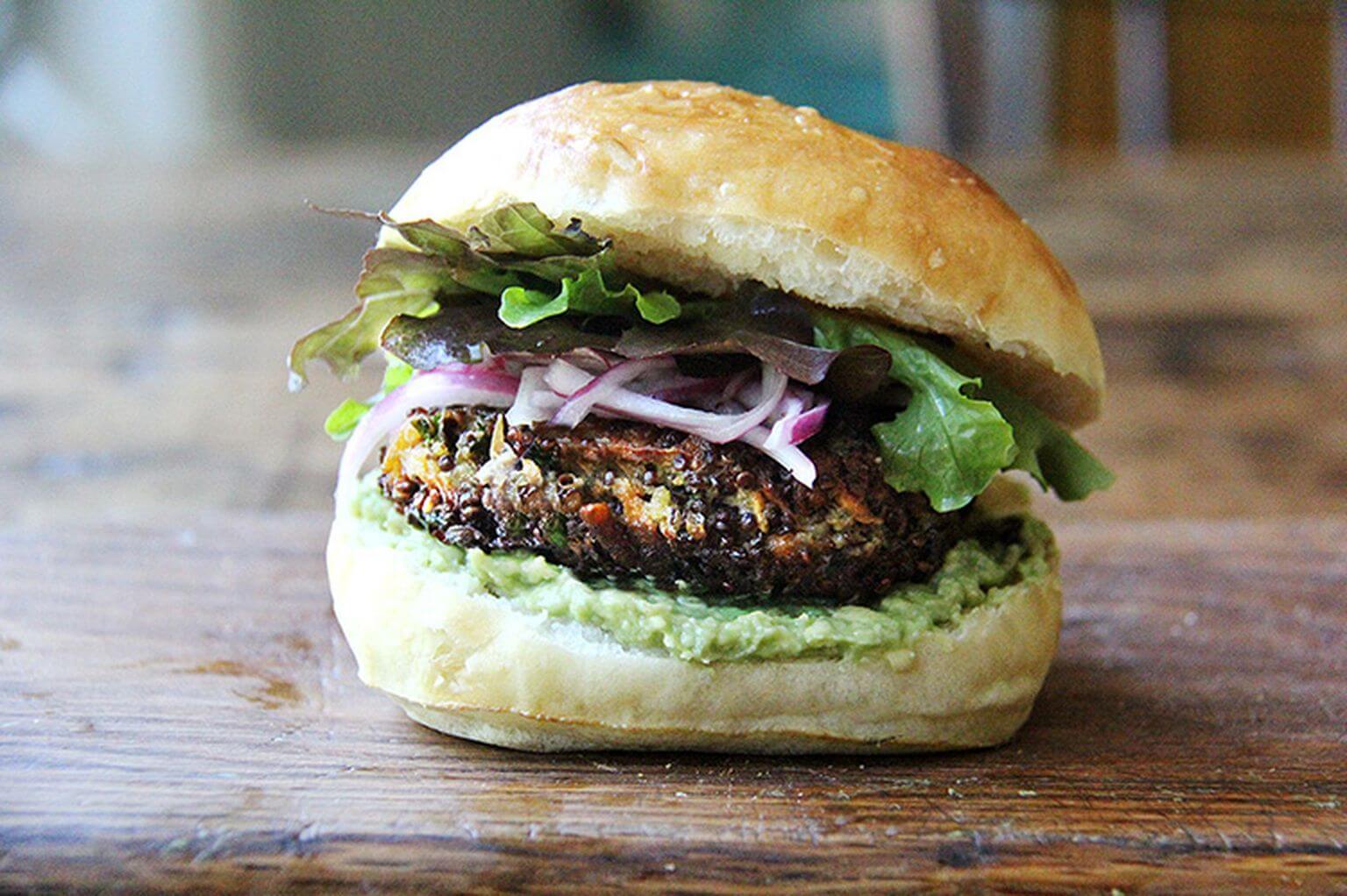 A mushroom-quinoa veggie burger on a board.