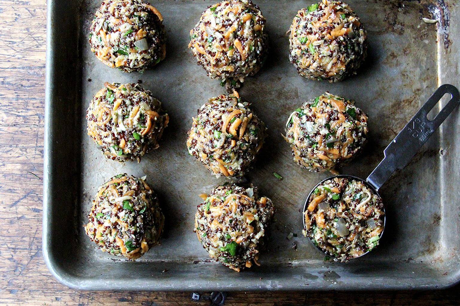 Portioned un-cooked veggie burgers on a sheet pan.