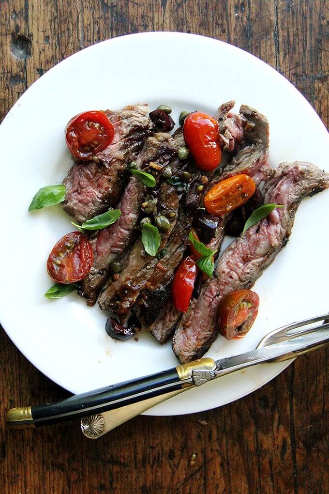 In this skirt steak nicoise, while the skirt steak rests, you’ll make a simple sauce Niçoise. After halving cherry tomatoes, coarsely chopping olives, and tossing the two with capers, you’ll briefly sauté the mix with olive oil and garlic. After just a few minutes, the tomatoes will begin to break down, releasing juices and sweetening as they soften. A squeeze of fresh lemon juice at the end offers a welcomed hit of acidity. // alexandracooks.com