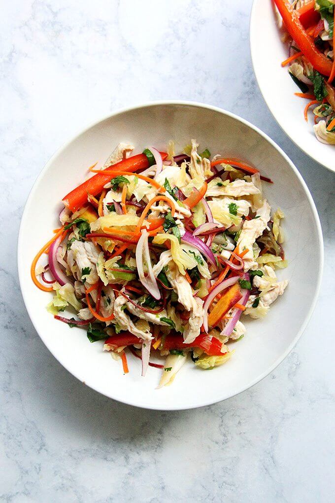 A bowl of chicken and cabbage salad with Thai dressing.
