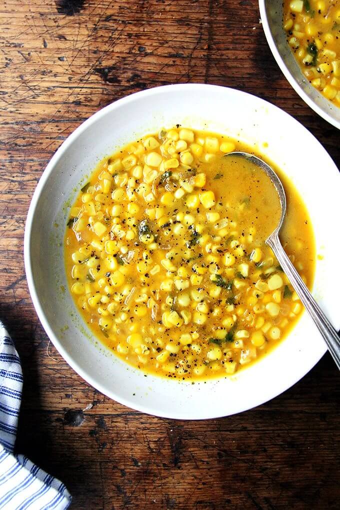 A bowl of curried corn soup with lime and coconut milk. 