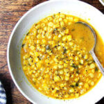 A bowl of curried corn soup.