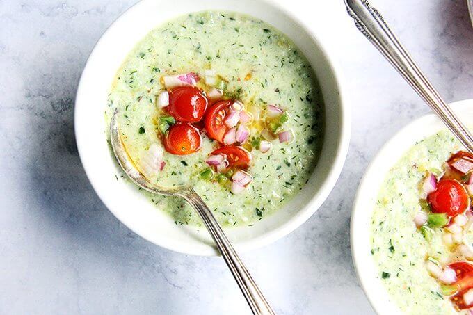 Two bowls of cucumber grape gazpacho with tomato salsa.