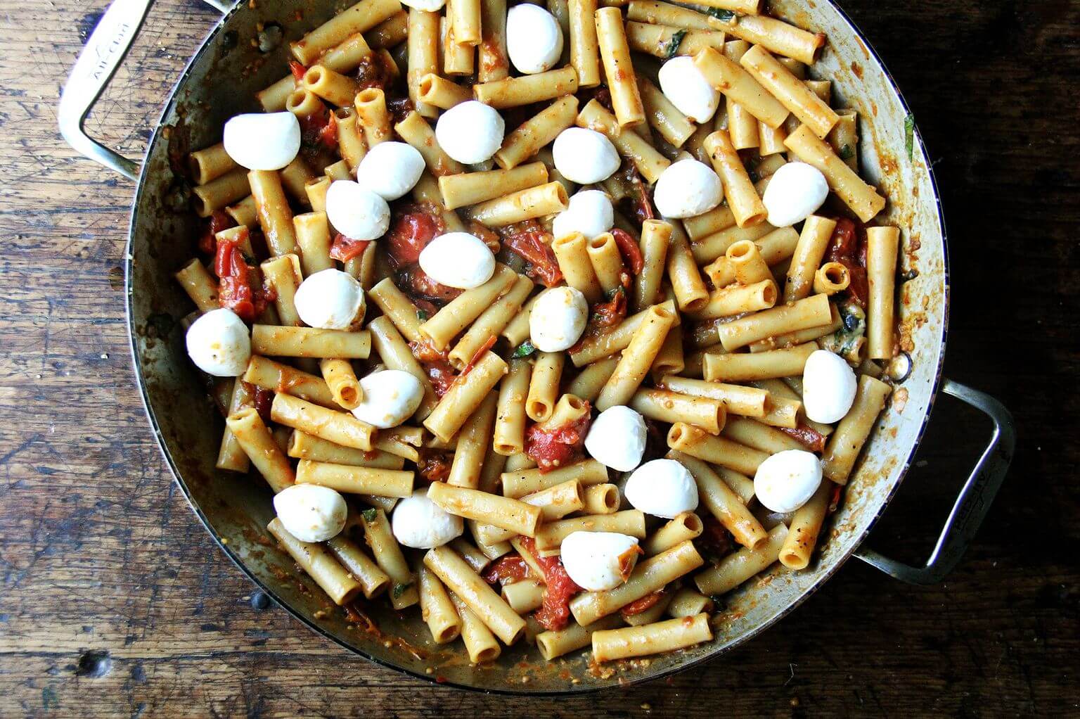 A large skillet of one-pan baked ziti topped with mozzarella.