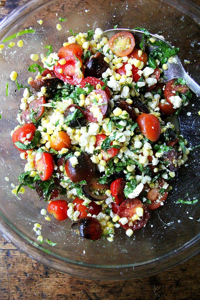 A bowl of corn and tomato salad. 