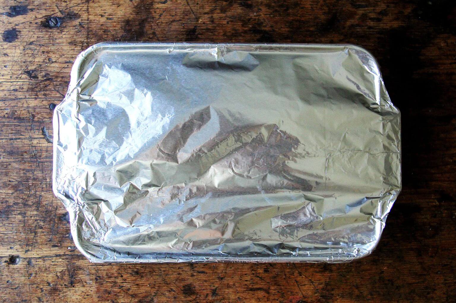 A 9x13-inch pan of unbaked lasagna covered in foil.