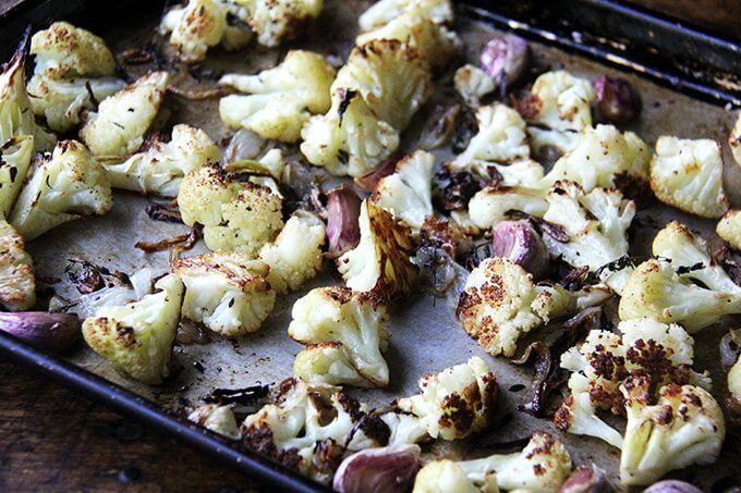 Oven-roasted cauliflower florets on a sheet pan. 