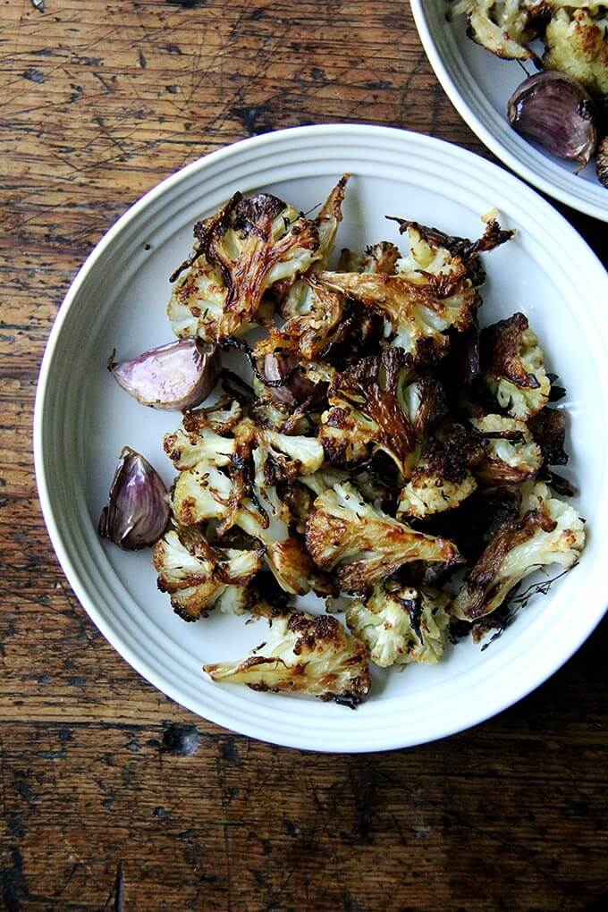 A plate of oven-roasted cauliflower with garlic and parmesan.