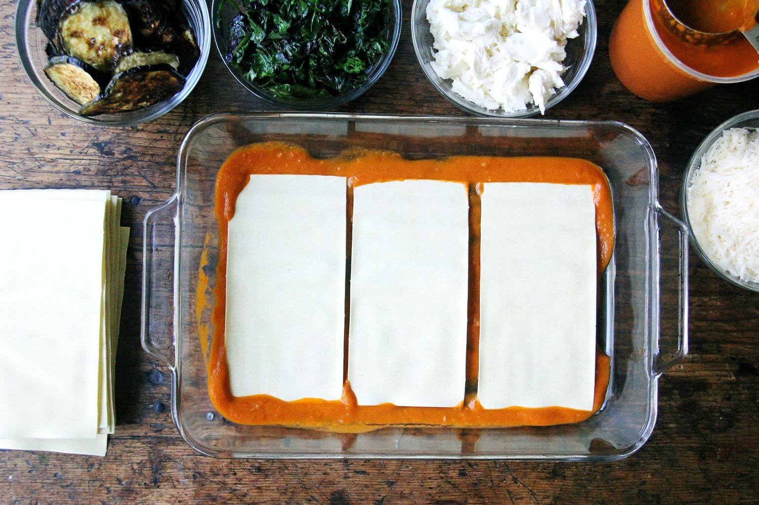 A layer of sauce and noodles in roasted eggplant Swiss chard lasagna.