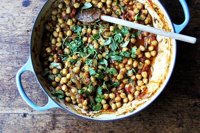 Chickpea tagine in a Le Creuset braiser sprinkled with cilantro.