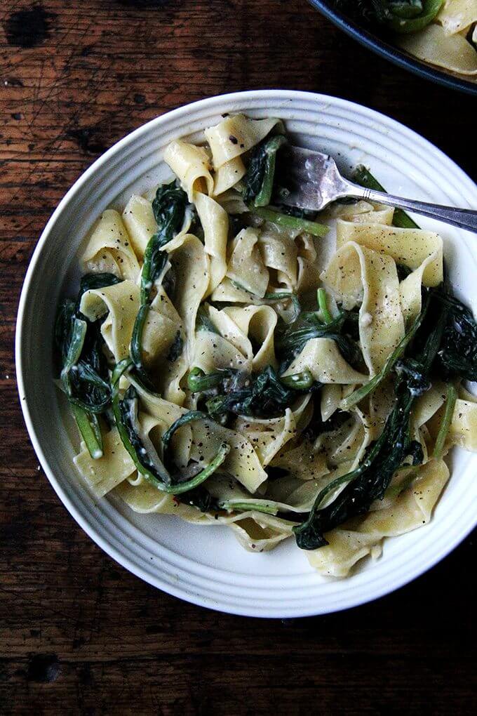 A plate of no-bacon carbonara loaded with greens.