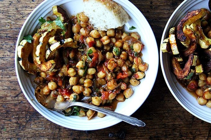 A bowl of chickpea tagine with roasted delicata squash. 