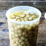A quart container filled with cooked chickpeas.