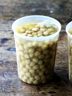A quart container filled with cooked chickpeas.