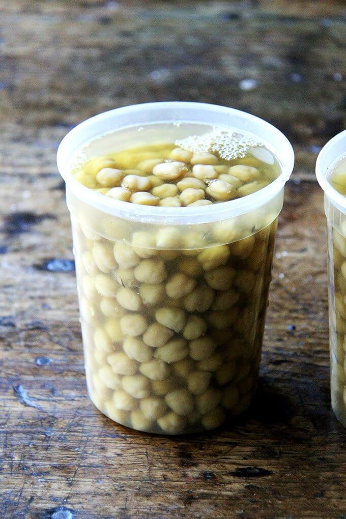 A quart container filled with cooked chickpeas. 