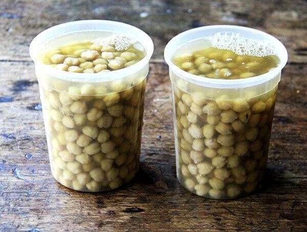 Two quart containers filled with cooked chickpeas.