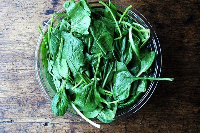 A bowl of greens soaking in water.