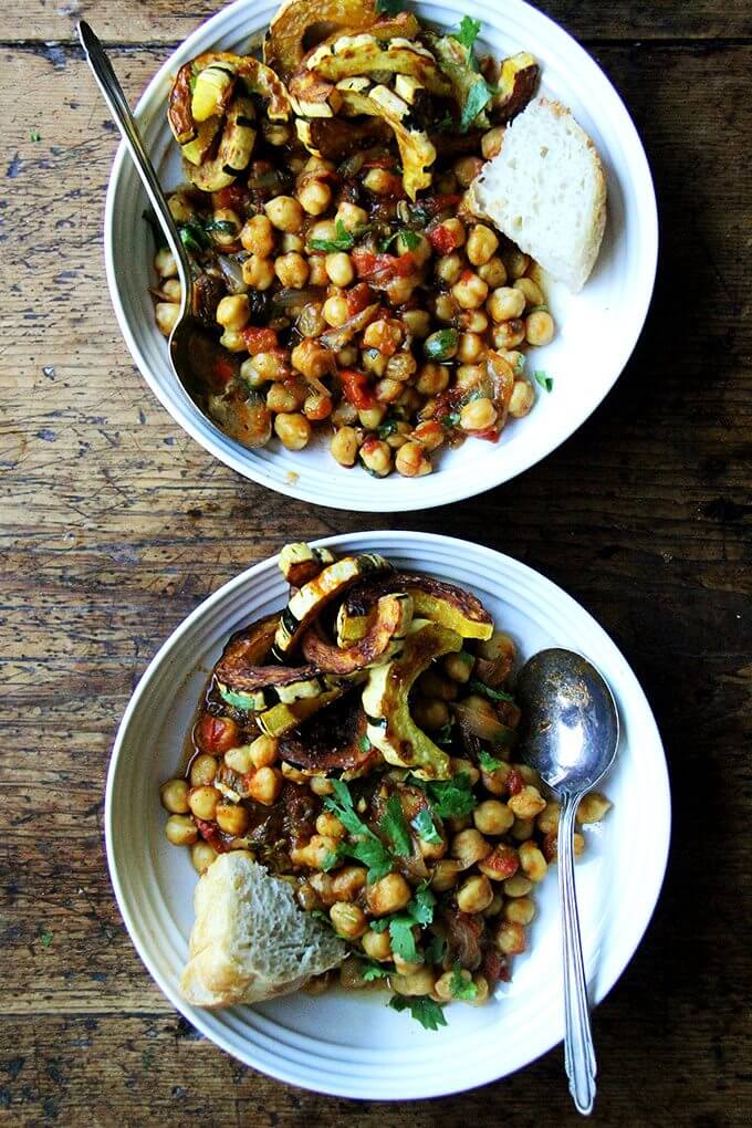 Two bowls of chickpea tagine with roasted delicata squash. 