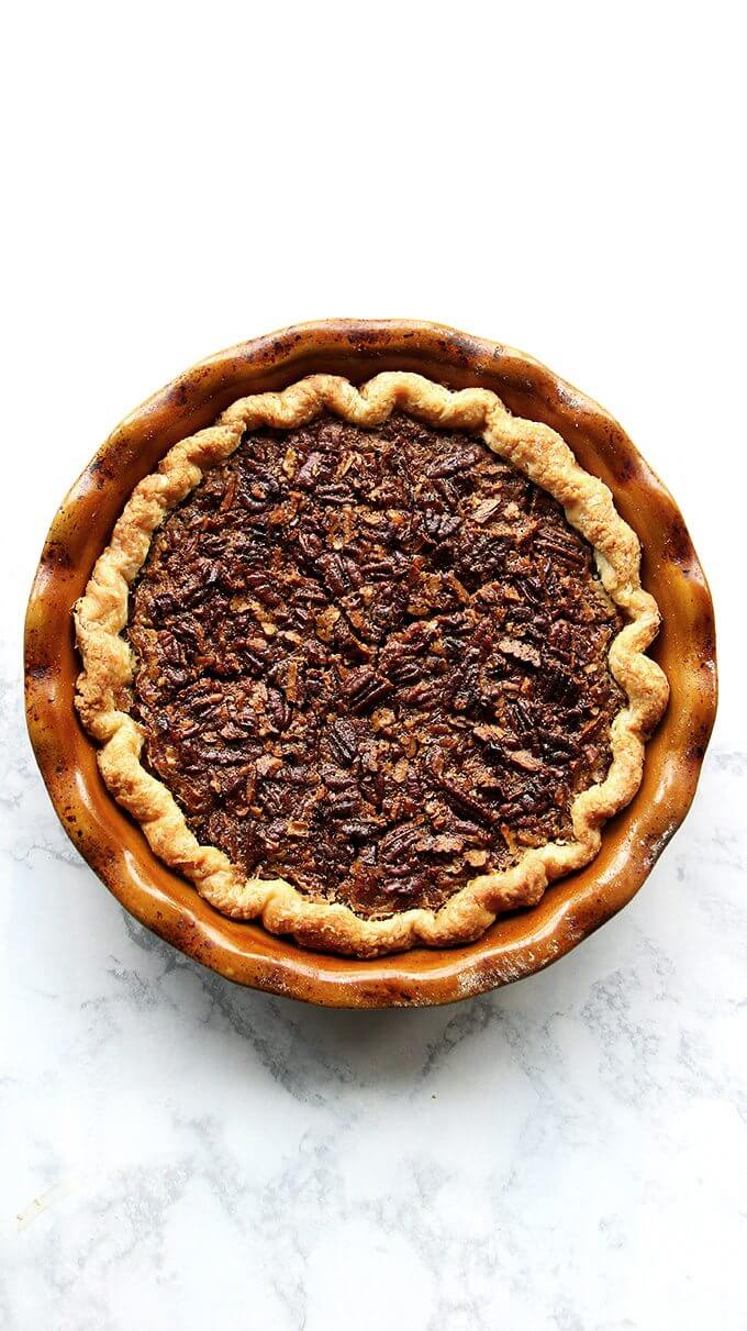 An overhead shot of a slice of no corn syrup bourbon pecan pie on a plate.