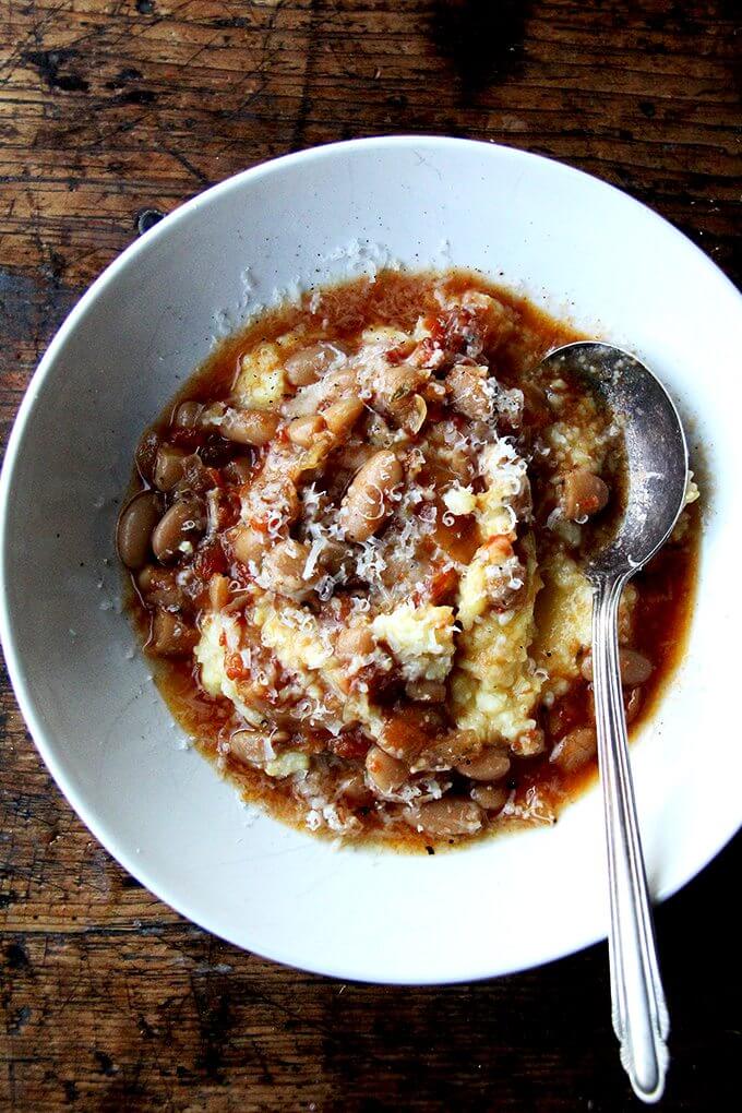 A bowl of slow-cooker beans with oven-roasted polenta.