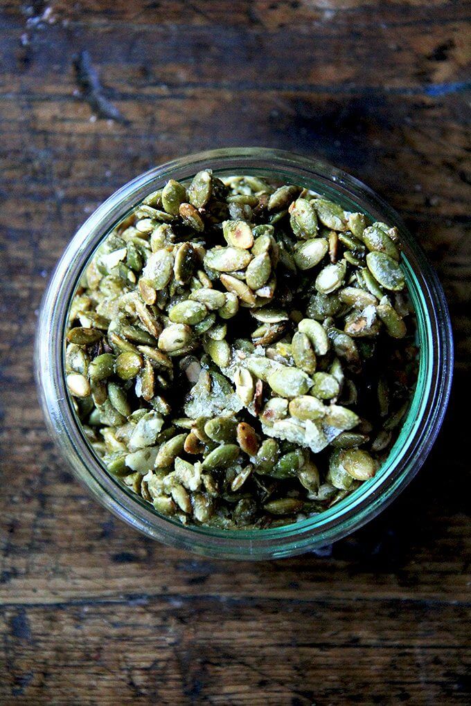 A jar of sweet and salty candied pumpkin seeds. 