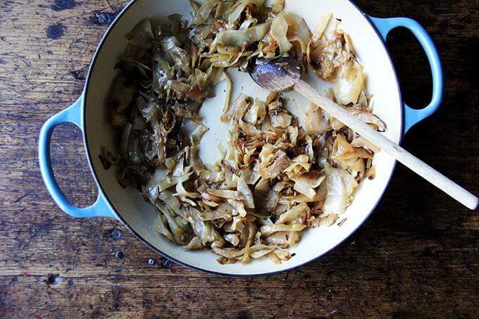 A braiser filled with caramelized cabbage.