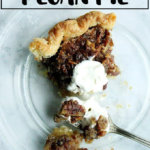 A slice of no corn syrup pecan pie with a dollop of whipped cream.