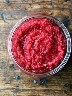 An overhead shot of a jar filled with no-cook cranberry sauce.