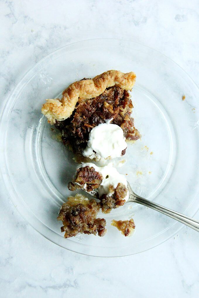 An overhead shot of a slice of no corn syrup bourbon pecan pie on a plate.