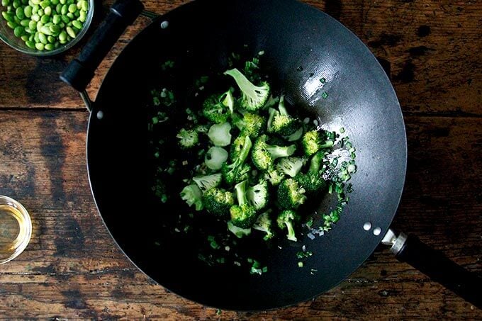 A wok filled with broccoli