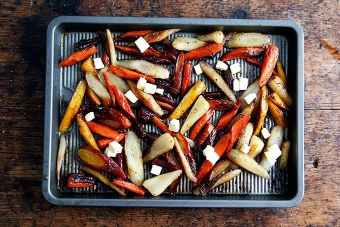 Sliced carrots on a sheet pan with butter and honey.