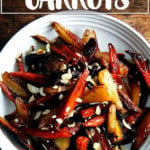 A bowl of roasted carrots with honey and almonds.
