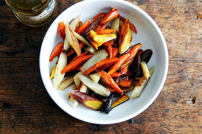 Sliced roasted carrots dressed in vinegar.