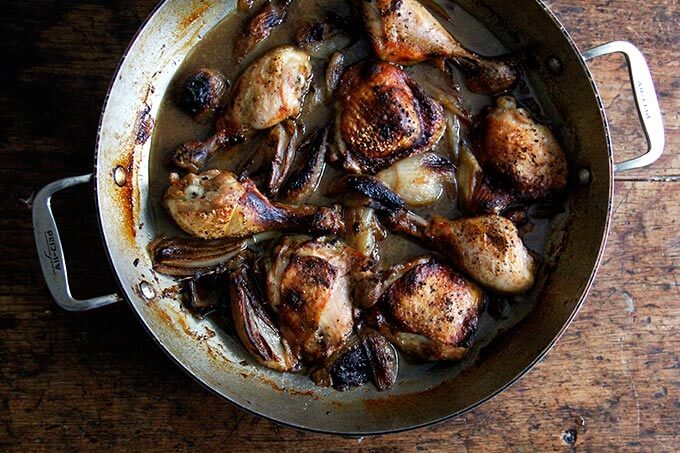 A pan of roast chicken and shallots.