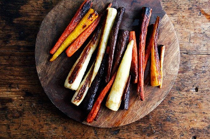 Roasted carrots on a board.