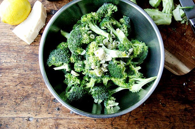 Broccoli florets in a bowl with garlic. 