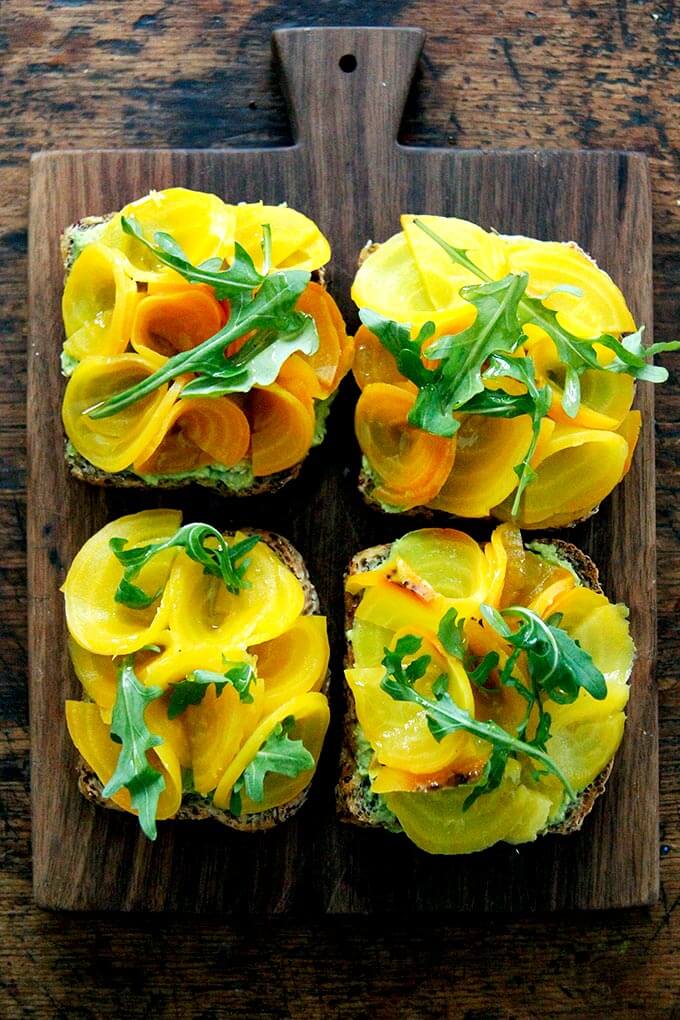 A board with avocado & beet tartines.