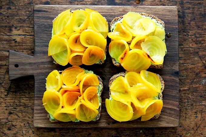 Avocado toasts topped with beet roses. 