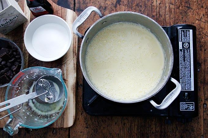 An over head shot of a portable burner holding a cream-egg yolk mixture. 