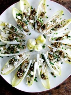 Endive boats with pear, blue cheese, candied pepitas, chives and citrus vinaigrette.
