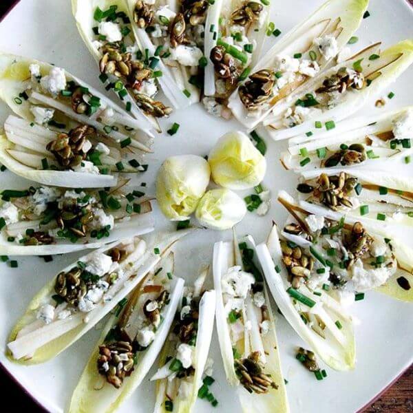 Endive boats with pear, blue cheese, candied pepitas, chives and citrus vinaigrette.