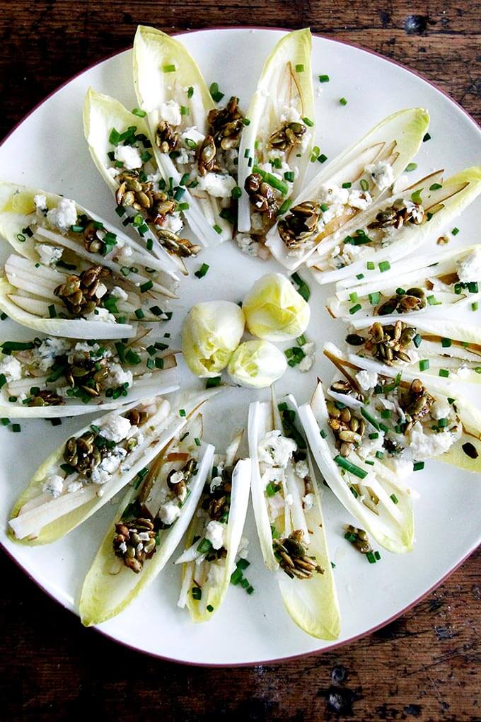 A platter of Endive Boats with Pear, Blue Cheese, & Shallot Vinaigrette.